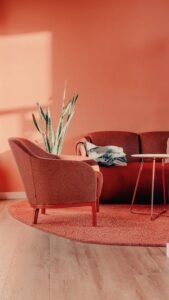 a stylish minimalist living room with peach walls and modern furniture in berlin, germany.